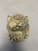 Front view of lion head sculpture showing overall appearance