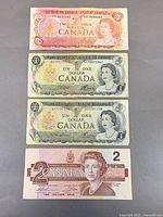 Fronts of four Canadian banknotes showing denominations and portraits