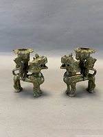 Front angled view of both candle holders showing form and material