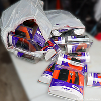 Overview of two white bags filled with sealed MetroPCS accessory packs