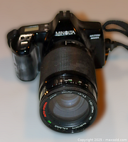 Front view showing Minolta Maxxum 3000i body with attached Kalimar zoom lens and strap