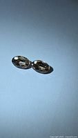 Pair of oval champagne zircons on light background