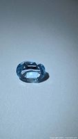 Front view of faceted oval blue topaz