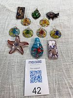 group shot of ten assorted glass pendants