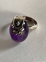 Ring front view showing amethyst cabochon and silver scroll
