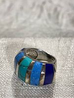 Oblique view of ring showing stone inlay and silver channels