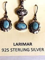 Full view of pendant and earrings on card showing larimar stones and 925 marking