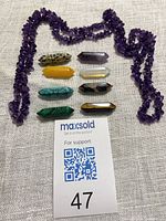 Group view showing all eight crystal points and amethyst chip strand