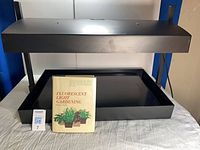 Full view of Garland grow light system with gardening book