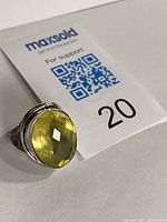 Ring with lemon quartz stone beside MaxSold tag