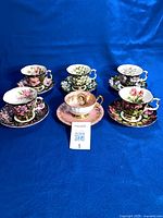 Group view of six teacup and saucer sets