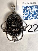 Front view of oval ocean jasper pendant in sterling silver frame