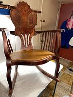 Front angle showing overall chair structure, slat arms, replaced seat