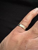 Ring on finger showing exterior design and width