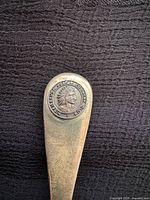 Close-up of finial showing Indigenous design and club name