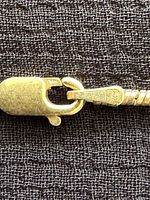 Close-up of stamped lobster clasp and chain texture