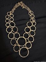 Full view of gold tone hammered circle necklace