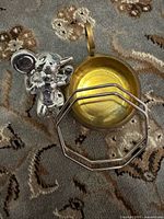 All three items: silver mouse figurine, brass bowl, octagonal bangle