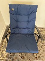 Front view of blue padded chair showing full seat, backrest, and metal frame