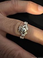 Front view of Claddagh ring on finger, showing heart, crown, hands