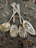 All four utensils arranged on rug showing overall forms