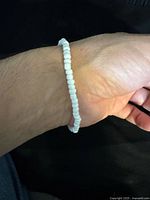Bracelet on wrist showing white beads