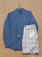 Shirt on hanger with shorts folded beside it