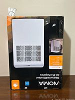 Front of boxed NOMA dehumidifier showing branding and capacity