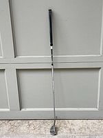 Full view of Odyssey putter showing head, shaft and worn grip