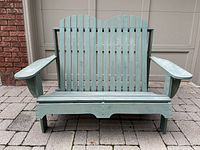 front view of green Adirondack two-seater bench showing full structure