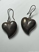 front view of both sterling silver puffy heart earrings