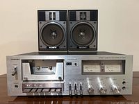 Front view of Toshiba PC-3460 cassette deck with two Sony speakers on top