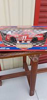 Front of boxed Bill Elliott #11 Budweiser die-cast model