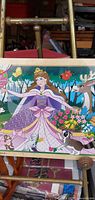 Front view of wooden jigsaw puzzle showing princess scene in tray