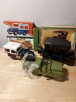 Group shot showing three Avon vehicle decanters and two boxes