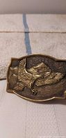 Front view showing raised eagle design on brass buckle