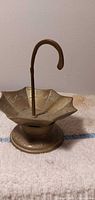 Full view of brass umbrella-shaped stand