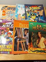 Group shot of all six coloring books spread on table