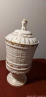 full view of porcelain urn with lid on