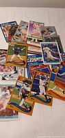 Pile of assorted Topps MLB trading cards spread on bed