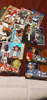 Group of assorted NFL trading cards spread on table