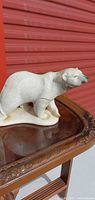 Front side view of composite polar bear figurine on table