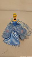 Front view of Cinderella tree topper showing figure and fabric dress