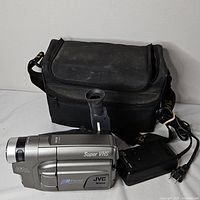 Camcorder, power adapter with cord and carrying case overview