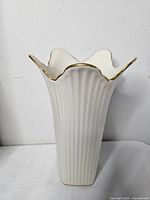 Front view of Lenox ribbed porcelain vase with gold-edged scalloped rim