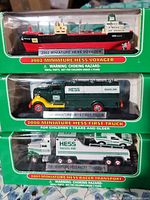 Stacked boxed Hess miniature vehicles showing fronts and labels