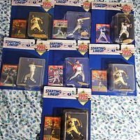 Eight sealed 1995 Starting Lineup baseball figures laid out