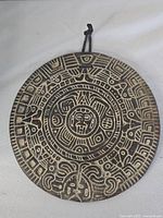 Front view of carved Aztec calendar plaque