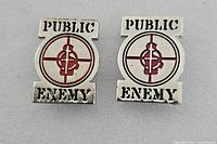 Front view of both Public Enemy pins showing enamel design and condition