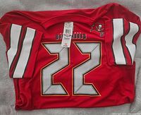 Front view of red Buccaneers #22 jersey with tags